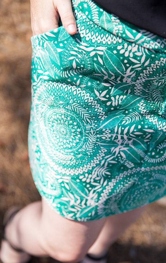 Image from above of a woman wearing a green and white leave and mandala doodle design made from Celosia Velvet.