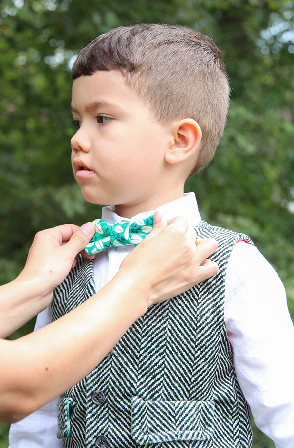 Celosia Velvet Boy's Vest A small, dapper boy outfitted in a black and white herringbone patterned Celosia Velvet vest.